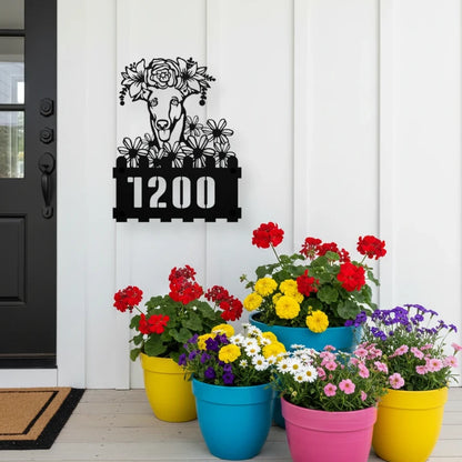 Greyhound custom metal house number sign in black, flush mounted on white porch siding beside a black front door with colorful potted flowers