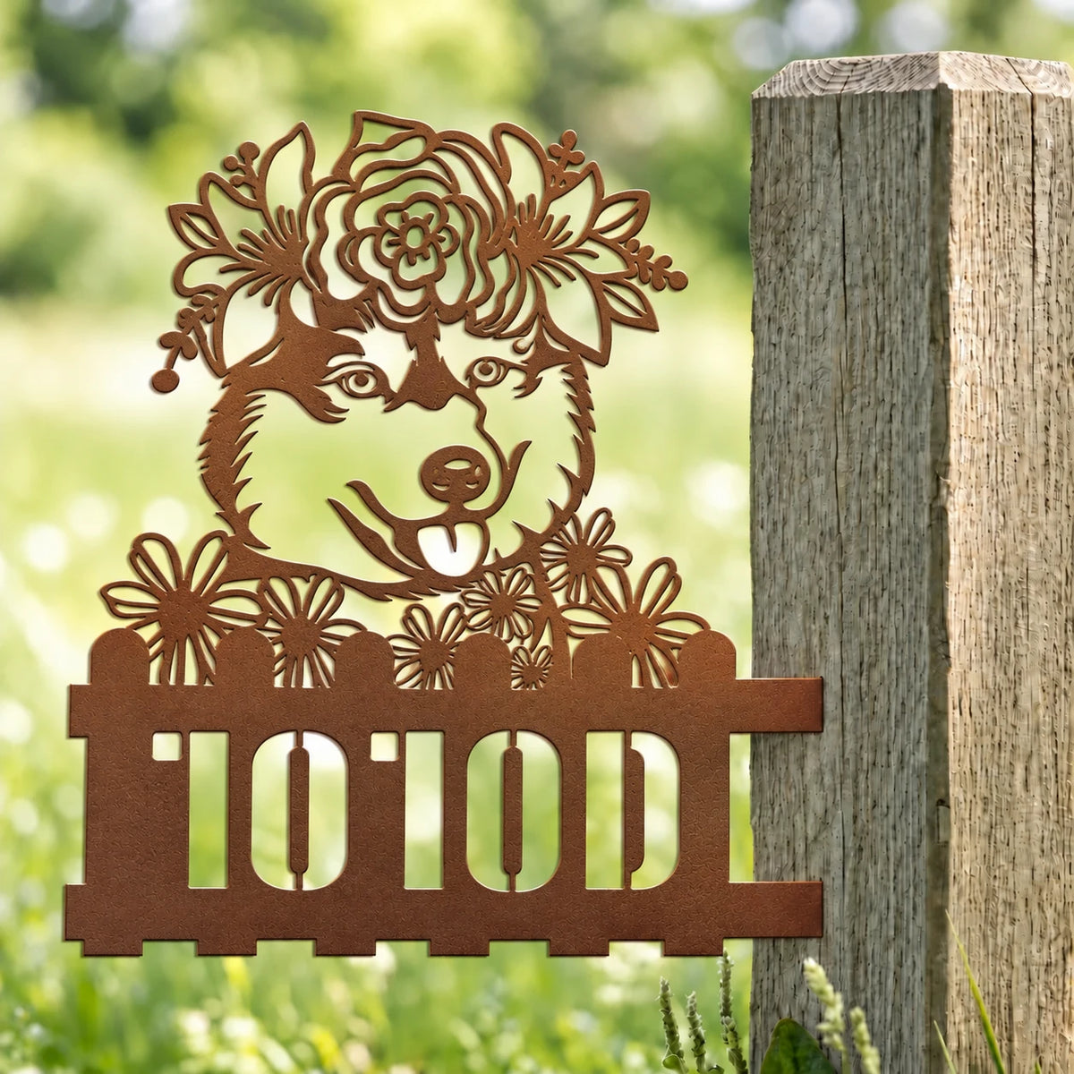 Husky custom metal house number sign with floral crown mounted on a garden post.