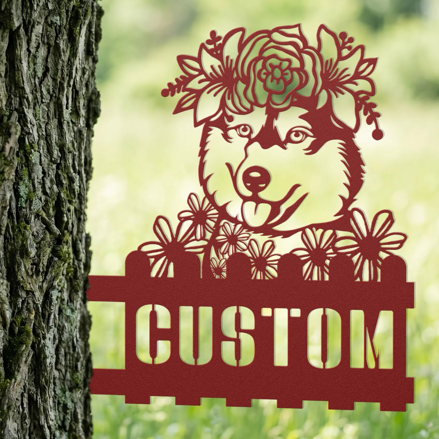 Decorative metal sign of a dog with flowers and 'CUSTOM' text against a natural background.
